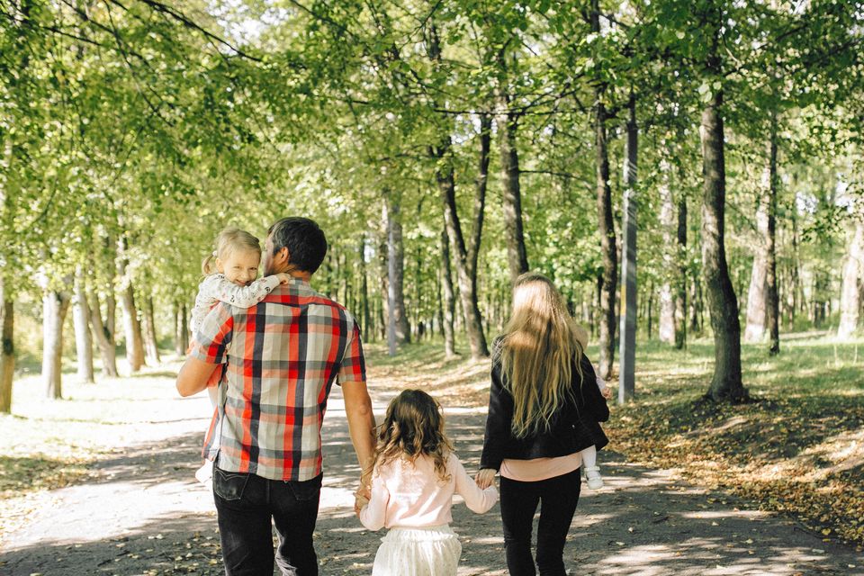 Family enjoying a walk through a park